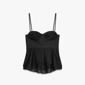 Oanvänd svart korsettopp med volang från Zara - Säljer en svart korsettopp med tunna axelband och volang nertill. Toppen har en söt byst med lätt rynk och en flowy, asymmetrisk nederdel. Perfekt att styla med jeans eller kjol för en trendig look.