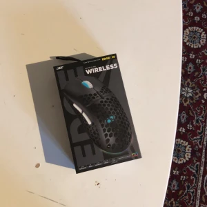 EDGE W Wireless Super Light Mouse - EDGE W är en trådlös superlätt gamingmus med RGB-belysning och honeycomb-design för optimal ventilation. Levereras i originalförpackning med manual. Perfekt för snabba rörelser och hög precision. Produkten ser ut att vara i nyskick utan synligt slitage.
