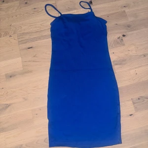 Kornblå tight klänning från Misu Amisu blå klänning, storlek 36 - Kornblå tight klänning från Misu med smala axelband och rak skärning. Klänningen är kort och har en enkel, stilren design som sitter figurnära. Perfekt för dig som gillar minimalistisk stil och vill ha något som sticker ut med färgen.Kort, blå klänning med smala axelband. 💙✨