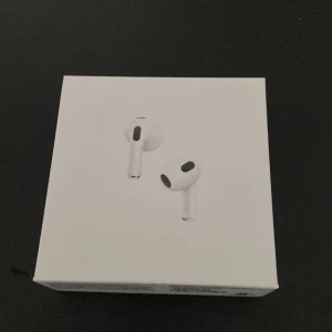 AirPods 3 - Säljer ett par Apple AirPods 3 i nyskick köpte fel modell, komplett med originalförpackning, laddningskabel och manual. Hörlurarna och laddningsetuiet är rena och utan synligt slitage. Perfekt för trådlös musik och samtal med hög ljudkvalitet. 