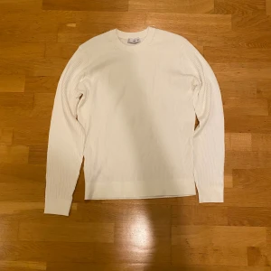 Vit ribbad stickad tröja från MNG/MANGO - Säljer en stilren vit stickad tröja från MNG i storlek S. Tröjan har ett ribbat mönster, rund hals och långa ärmar. Perfekt för dig som gillar minimalistisk och clean look. Materialet är mjukt och skönt, passar till många olika outfits. (det är slim fit ochså)