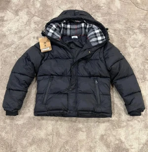 Burberry väst/jacka helt ny - Jackan är helt ny med tagsen kvar. Den sitter rätt i storlek.                           Fraktas samma dag vid köp. Perfekt för julklapp 🎁🎁. Den enda problemen på jackan är knappen som lossnats därför säljer jag jackan för detta pris. Det kostar max 50kr att fixa hos en textilier. Knappen i slutändan är inte något som påverkar jackans utsikt,