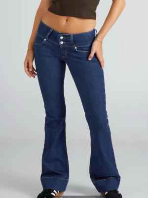 Mörkblå bootcut jeans med låg midja - Säljer ett par mörkblå jeans från junkyard med låg midja och bootcut passform. Byxorna har två knappar framtill, klassiska fickor och är tillverkade i ett stretchigt jeansmaterial. Säljer då jag tyvärr köpte fel storlek. Nypris 700kr💞