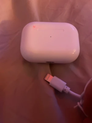 AirPods Pro - Säljer ett par AirPods Pro med laddningsetui och lightning-kabel. Hörlurarna och etuiet ser ut att vara i gott skick utan synligt slitage. Aktiv brusreducering och trådlös anslutning för bästa ljudupplevelse. Perfekt för musik, samtal och träning.