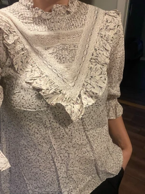 Krämfärgad blus/topp med diskret blommönster från H&M, storlek 34 - Krämfärgad blus/topp med diskret blommönster från H&M, storlek 34. Ny!