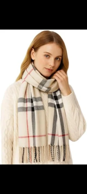 Halsduk i kashmir  - Snygg beige kashmir halsduk med klassiskt rutigt mönster i svart, grått och rött. Mjukt material med fransar i ändarna, perfekt att vira flera varv runt halsen. 