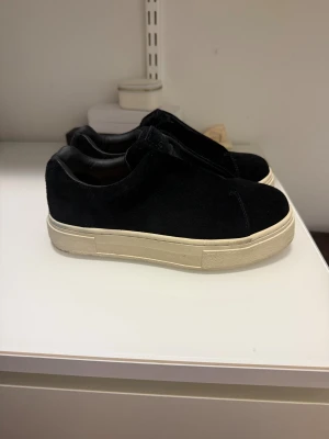 Svarta Eytys doja - Säljer ett par svarta sneakers från Eytys med tjock vit plattformsula. Skorna har en stilren design utan snörning, med ovandel i mocka och insida i skinn. Använda ett fåtal gånger och är i väldigt bra skick. Nypris 2200kr