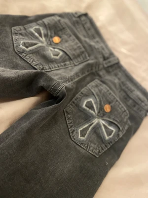 Jeans från Gina tricot - Jättefina jeans från Gina tricot med bling mönster på bakfickorna. Har en klassisk femficks design och är lowrise och bootcut. Har ett 