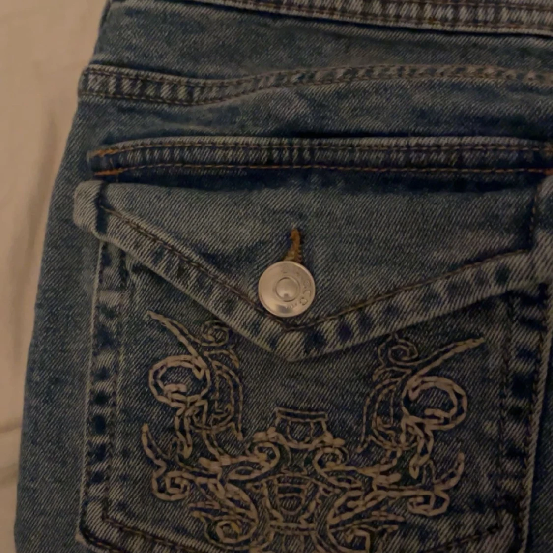 Blå jeans med broderade fickor - 91