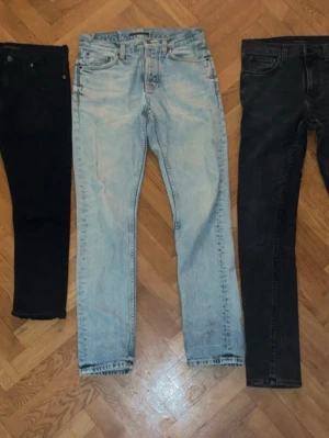 3x Nudie Jeans - Säljer 3 par Nudie jeans för ett bra pris👍              Svarta: Klippta vid fötterna W30 L32 (6/10)             Ljusblå: Många defekter W29 L32 (3,5/10).                Svarta/grå: Lite använd längst ner W30 L32 (9/10)