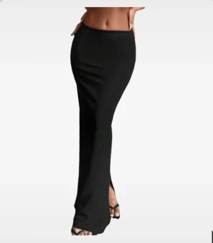 Svart långkjol med slits - Säljer en lång svart kjol med slits vid sidan Kjolen ar välanvänd men ser fortfarande väldigt bra ut!