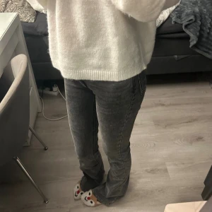 Grå bootcut jeans med tvättad look - Köpta för 499, använda 1 gång. Ett par grå jeans med tvättad effekt och bootcut-modell. Jeansen har klassisk femficksdesign och normal passform upptill som blir utsvängd nertill. Materialet är jeans och färgen är en snygg mörkgrå ton.