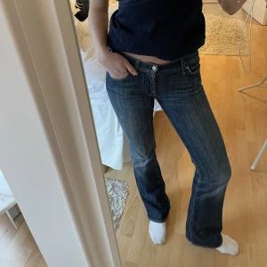 Lågmidjade bootcut - Mörkblå Lågmidjade bootcut jeans från 7forallmankind. Dessa jeans sitter som en smäck!! Börjar bli lite för små. Är 168 cm lång, passar mig perfekt längdmässigt! 24 i midjan. Skriv för fler bilder!  