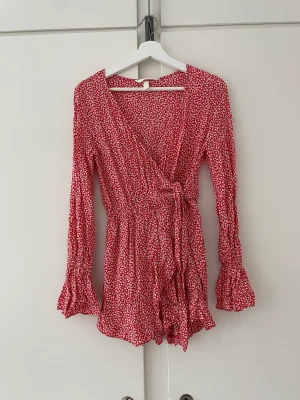 Röd Hm jumpsuit  - En röd jumpsuit från Hm, ser ut som en klänning på. Knappt använd.