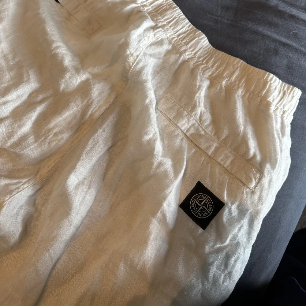 Säljer dessa vita linne byxor för herr! Inköpta på Stone Island butiken, nypris ca 4000kr. Inga defekter, använd fåtal gånger så dom är i nyskick. Skriv för fler bilder 🤍 killen på bilden är 191cm lång, snören finns i midjan. Jeans & Byxor.