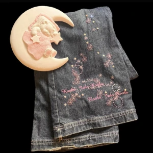Bootcut j€ns stor efterfrågan  - Bootcut jeans med söta rosa detaljer/ broderi blommor/stjärnor längst ner på ena benet.  Tyvärr  står det ingen storlek kvar i dom men om du är intresserad så mätter jag dom åt dig. (Minimal slitage längst ner vid slutet, man ser på första bilden)<3 36cm