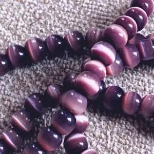 Två elastiska armband med skimrande lila stenar   