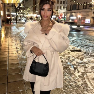 Vit kappa med päls - Säljer denna helt oanvända kappan som är köpt för drygt en vecka sen i färgen off-white. Kan visa kvittot. Pälsen är äkta och avtagbar. Pris kan diskuteras 🤍