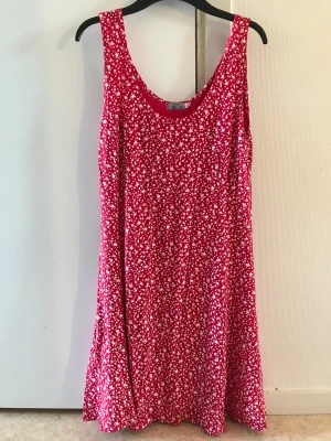Röd klänning  - Säljer denna röda klänningen med blommor på