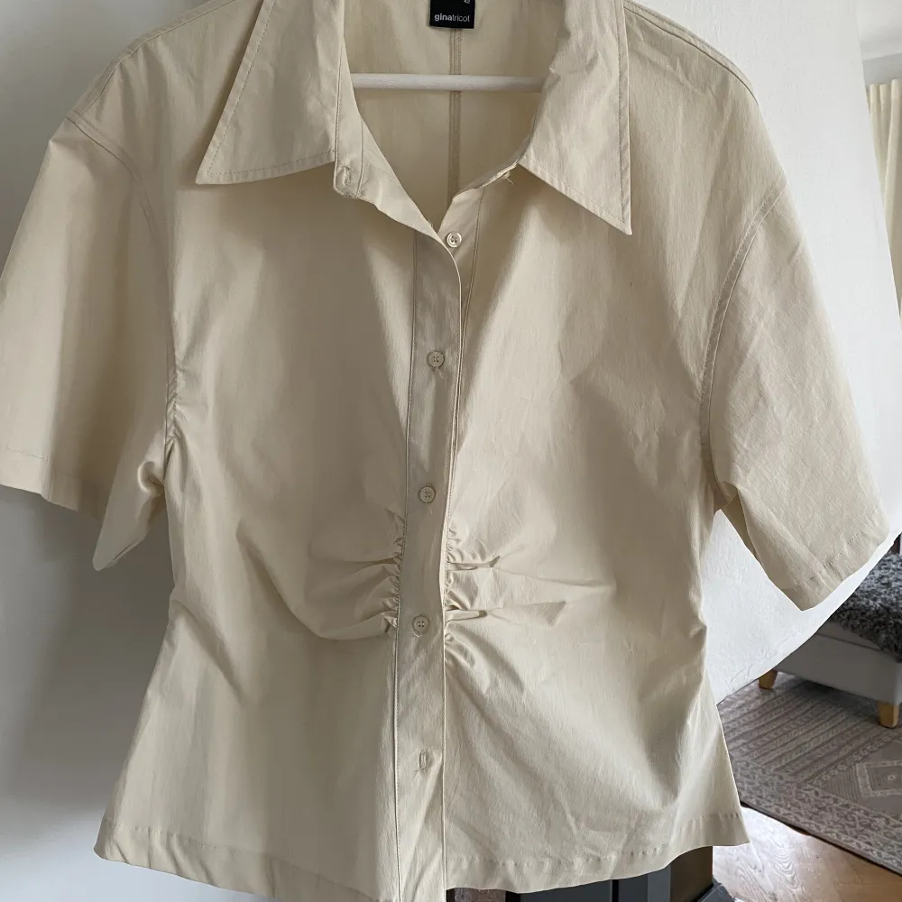 Säljer denna fina skjorta/blus från GinaTricot i beige färg. Storlek 42. Endast använd fåtal gånger så skjortan är i bra skick.🌟Frakt tillkommer. . Skjortor.