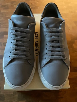 Clean 90 Axel Arigato (BUDA) Nypris 2450kr - Clean 90 Sneaker Light Grey Axel Arigato  Allt som ingår: - Skor - Original Låda - Original Påse - Klistermärken - Crease skydd  Kvitto finns  Skriv gärna om du har några frågor!  Buda på!!! Högsta bud får dem