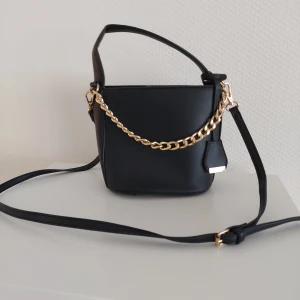 Svart bucketväska  - Svart bucketväska från Glamorous, använd endast 1 gång.  Mått: 20 cm bred och 17 cm hög.