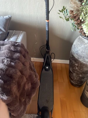 Svart elscooter Ninebot - Säljer en svart elscooter från Ninebot med digital display som visar hastighet och batterinivå. Scootern har en robust design med halkfri platta och smidigt styre. Perfekt för att ta sig runt i stan på ett snabbt och enkelt sätt.