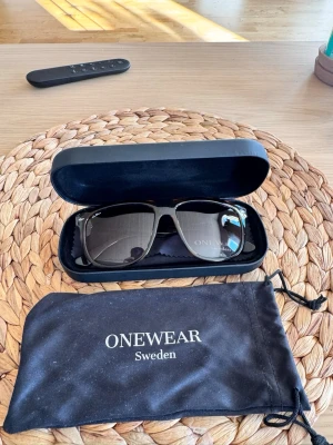 solglasögon från ONEWear - Snygga solglasögon från ONEWear Sweden med klassisk rektangulär form. Kommer med hårt fodral, tygpåse och putsduk,Perfekta för soliga dagar och ger en stilren look. Finns inte att få tag på längre, jätte bra skick inte massa repor