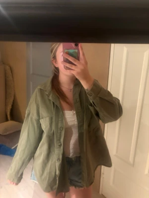 Grön oversize jeansjacka från 157 S/M - Säljer en oversized grön jeansjacka från 157 i storlek S/M. Skjortan har knäppning framtill, klassisk krage och två stora bröstfickor och slits på sidan. Den är ganska tunn så perfekt för sommaren 