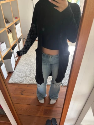 Svart lång cardigan  - Svart lång kofta från Vila mjukt matrial. Inga hål eller liknandes men bara lite knoppning 