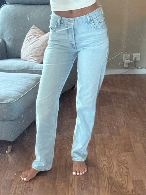 Ljusblå raka Levi's jeans - Säljer ett par ljusblå raka jeans från Levi's med klassisk femficksmodell och hög midja. Jeansen har en avslappnad passform och är tillverkade i denim. Perfekta för dig som gillar en tidlös och clean look.