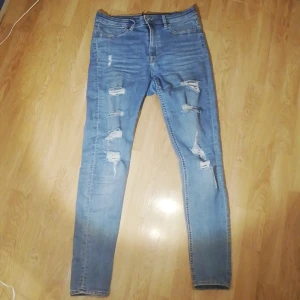 Byxor  - Ett par byxor med hål i från H&M med rätt så hög midja rätt så stora i storleken 