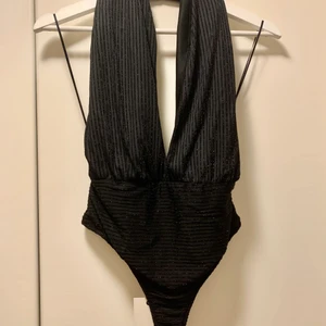 Glittrig body - M (ny!) - Superfin body med svart glitter, helt oanvänd med tagg - kostade 249kr ny, säljer för 200kr  Storlek M  Frakt betalas av köparen