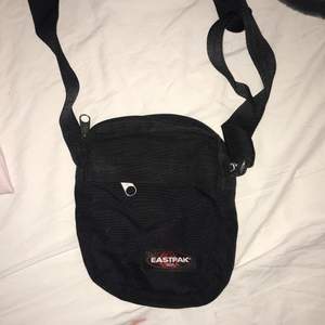 black small fannypack with 1 main pocket and 2 small ones