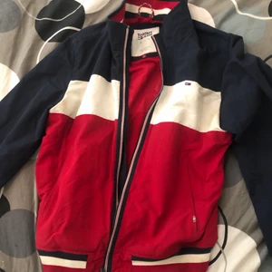 Tommy hilfiger jacka blå,vit,svart  - En extremt snygg Tommy hilfiger jacka nästan alldrig använd. Strl L men passar även om du har M. Köpt på Tommy hilfigers hemsida för 1600. Pris går att diskutera!