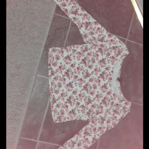 Divided - Här säljer jag en magtröja som är rosa blommor och är väldigt fin, storleken är XS tar emot kontanter 