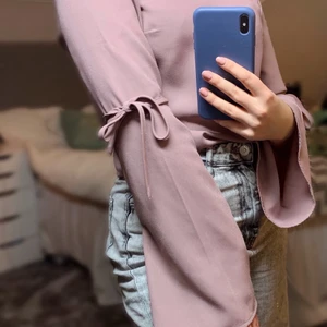 Blus - Gullig blus från Nelly med V-ringad rygg och knyten vid armbågarna. Storlek 36 i mycket bra skick!