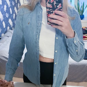 Ralph Lauren jeansskjorta i strlk S - Jättefin och sparsamt använd Ralph lauren skjorta i jeansliknande material. Köpt i USA 🇺🇸 Säljer den pga att jag växt ur den. Det är en S men jag skulle säga att den sitter som en XS/S🥰💕