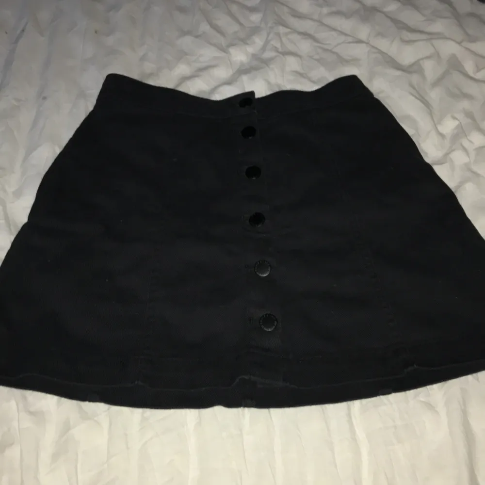 svart kjol men mellan stora knappar på dom går och öppna! aldrig använd. Kjolar.