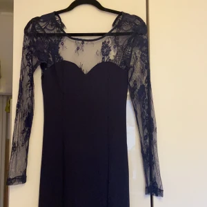 Klänning  - Figurformad klänning med öppen där bak. (Färg mörkblå) Haft den på min bal i Max 3 tim så är som ny. Den har en dragkedja där bak som gör att det blir enklare att sätta på den. 
