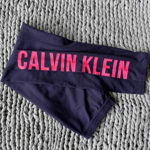 Träningstights Calvin Klein. Mörkblå med rosa print på benet. Högmidjade, skön passform och få skavande sömmar. Str S passform S-XS