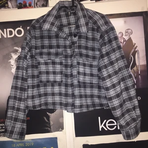 Rutig skjortjacka - En rutig croppad skjortjacka, svart och blå. Knappt använd. Storlek L men skulle säga att den är mer som en M, ganska tjockt material, passar till höst. 