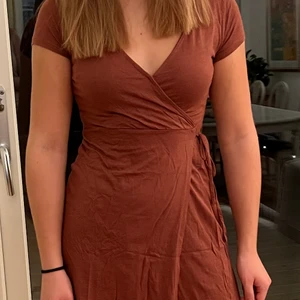 Omlottklänning H&M - Klänning som går omlott från H&M i en roströd färg. Har sytt uppe vid bröstet några stygn så att den inte är så öppen längre, den är i bra skick! 