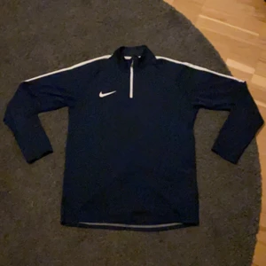 Snygg nike sweatshirt! - Nike zip sweatshirt inga fläckar. 2 pytte små flaws på höger arm syns knappt se bild 2 syns något mer i värkligeten men synd fortfarande inte om man inte kollar noga.          Obs placket är inte den blå färgen som syns på bild 2      bara blixen som gör de ser så ljus ut.  Tröjan är gjort i typ tränings kläder material som gör att den är super skön och ha på sig. Passar mig perfect och jag är ca 170cm lång och väger ca 63kg  För mer info skicka pm!   