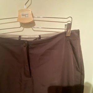 Låg midjade byxor  - Ett par bruna lågmidjade byxor, storlek 38 och är 40 cm i midjan. De är så fina och faller fint på benen och över skorna. 