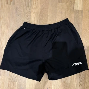 Svarta sportshorts från Stiga S - Stiga unit shorts i svart färg.  Herr storlek Small  Obs säljes ej nya längre men vid tid av köp ca 500kr.  Lätta shorts i stretchigt, snabbtorkande material som ger dig maximal rörelsefrihet och håller dig sval och torr.  Passar all typ av träning.  Innerbyxa i luftigt nättyg samt praktiska fickor fram. Praktiska fickor fram. Luftigt nättyg på insidan.  Material: 100 % polyester. Använda fåtal gånger (max 10 maskintvättar)