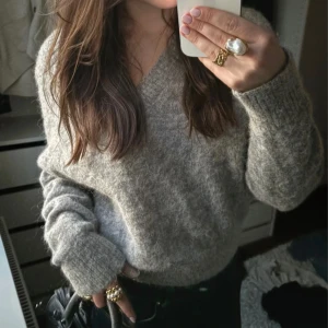 Grå stickad tröja med v-ringning - Fin grå stickad v-ringad tröja, passar XS-M. Nyskick