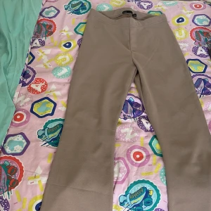 Beige bootcut byxor från 157 XS - Snygga beige bootcut byxor från 157 i storlek XS. Byxorna har en mjuk och stretchig känsla, med hög midja och raka ben som slutar i en lätt utsvängning. Perfekta för en chill och stilren look.