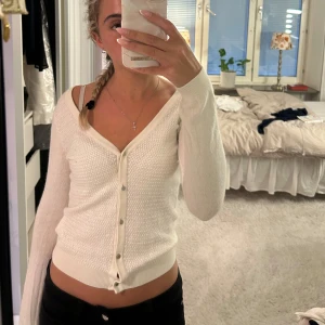 Vit kofta från H&M - Säljer en krämvit kofta från H&M som man även kan ha som en tröja. Tröjan har ett litet hål på armen som man kan se på andra bilden. 