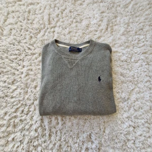 Grå stickad tröja Polo Ralph Lauren - Super snygg grå stickad tröja från Polo Ralph Lauren. Tröjan är nästan aldrig använd och är i väldigt fint skick! Pris kan diskuteras!